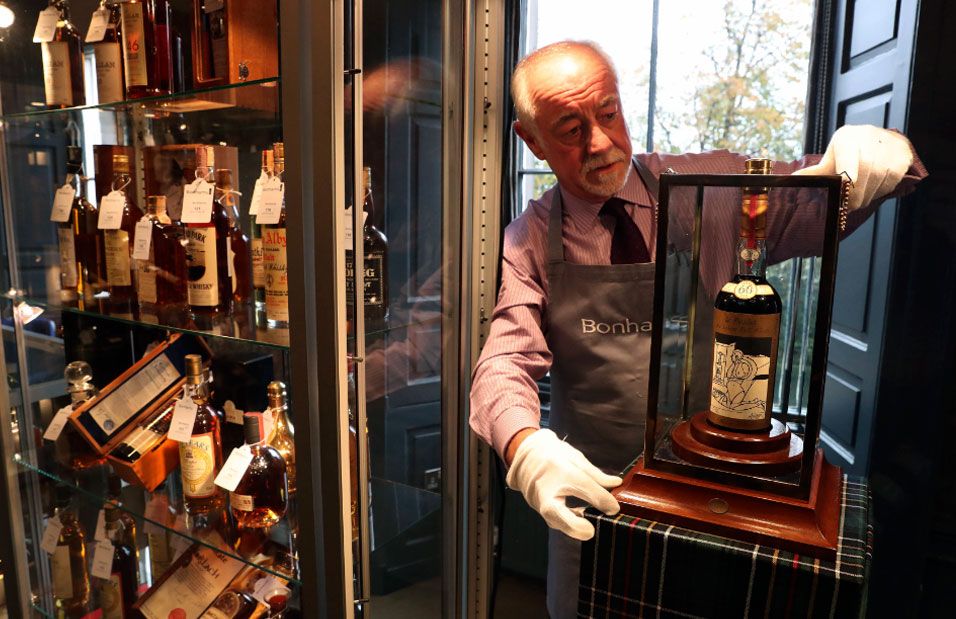 Danny McIlwraith, from Bonhams auction house, holds the bottle of The Macallan Valerio Adami during the auction in Edinburgh, Scotland.
