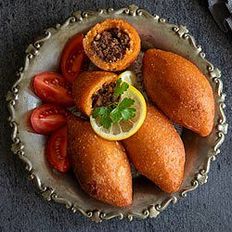 Plate of kibbeh and tomato wedges (Getty)