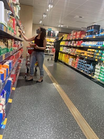 Jo looking at groceries at Aldi.