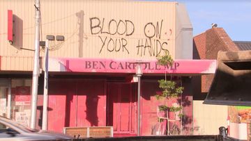 Two charged after deputy premier's office vandalised with fake blood