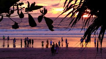 Bali, Indonesia - January 21, 2022 : Tourists enjoying sunset at Petitenget Beach, Bali, Indonesia