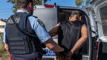 A man is arrested during Operation Amarok II, a domestic violence crackdown in NSW.