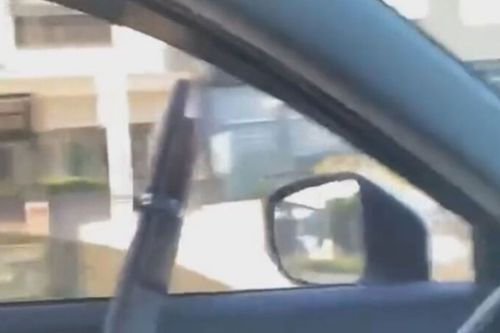 Man arrested after allegedly firing gun from moving car
