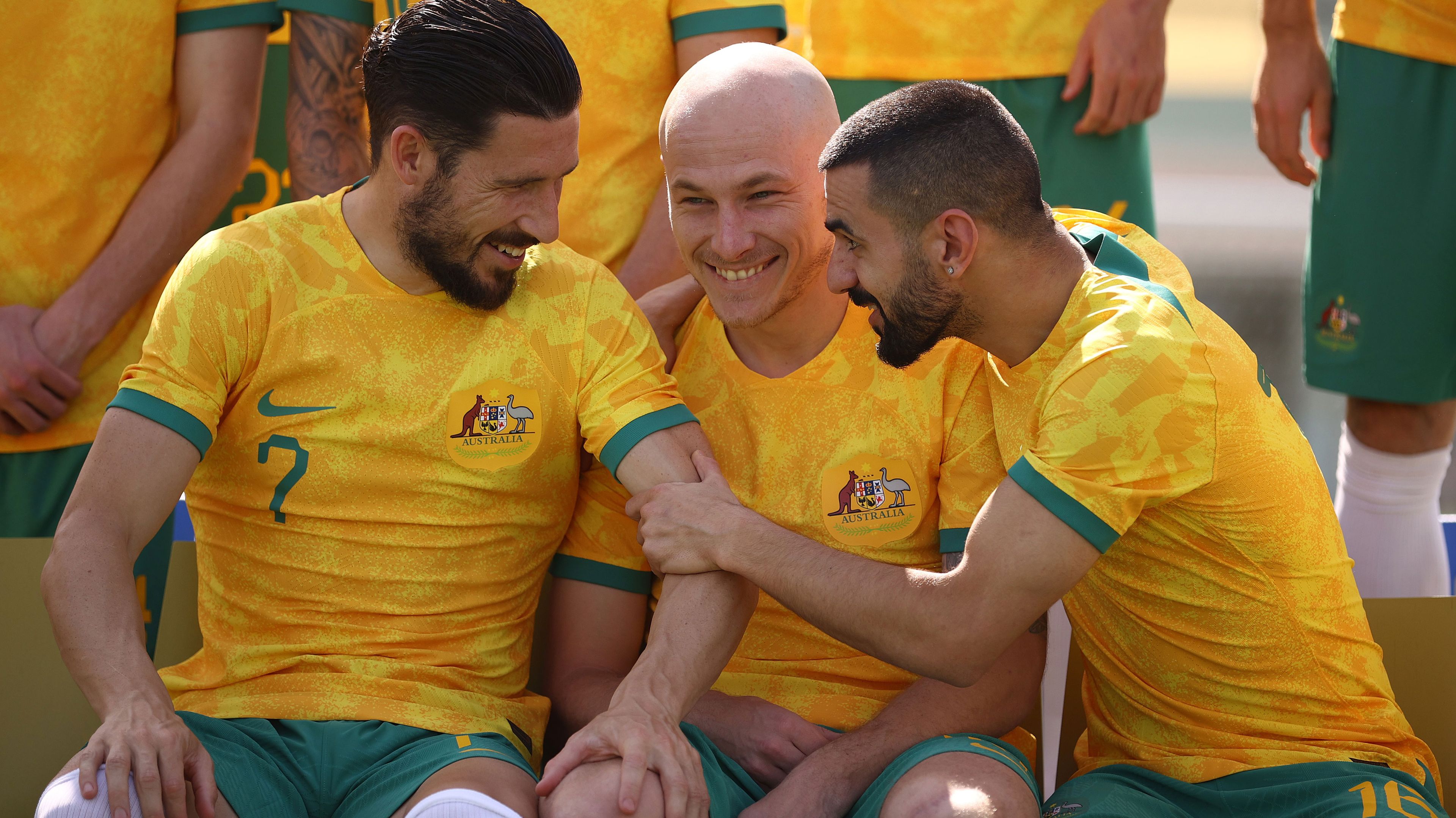 Mathew Leckie, Aaron Mooy and Aziz Behich pictured clowning around during the Socceroos&#x27; official team photo in Qatar.