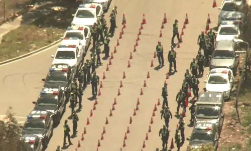 Authorities have set up an elaborate checkpoint with roads blocked off and hundreds of witches hats lining the road in Sunshine West.

