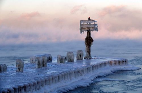 A harbor light is covered by snow and ice on Lake Michigan.