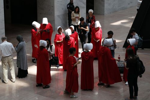 Demonstrators protesting against Supreme Court nominee Brett Kavanaugh, wear costumes from the show "The Handmaid's Tale," during his confirmation hearing with the Senate Judiciary Committee on Capitol Hill