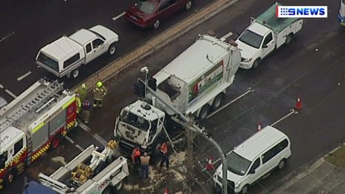 Driver rescued after two garbage trucks collide on NSW Central Coast Highway