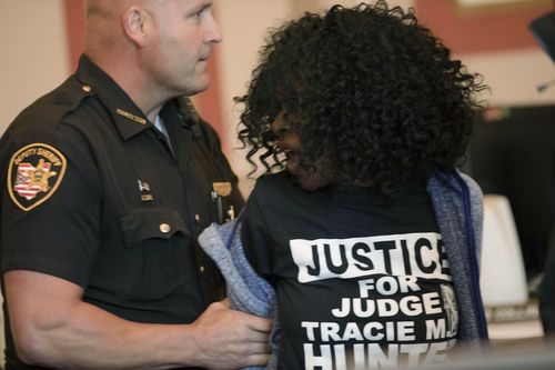 A woman is taken into custody after jumping the rail after former judge Tracie Hunter was ordered to serve her sentence of six-months in jail by Judge Patrick T. Dinkelacker.