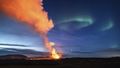 Northern Lights shine over erupting Icelandic volcano