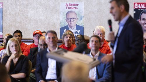 An image of Opposition Leader Anthony Albanese is seen in background as Shadow Treasurer Jim Chalmers speaks during a campaign launch event in Logan, Queensland.