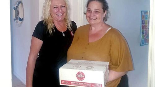 Karen Alisia from Keith's Quality Foods, picutured with Leanne Page after dropping off a box of the dagwood dogs.