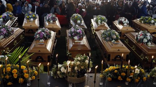 File - Coffins of 21 teenagers who died in a mysterious tragedy at a nightclub in the early hours of June 26, 2022 are lined up during their funeral held in Scenery Park, East London, South Africa, Wednesday, July 6, 2022. The toxic chemical methanol has been identified as a possible cause of the deaths of 21 teenagers at a bar in the South African city of East London last month, authorities said at press conference in East London Tuesday. July 19, 2022.  (AP Photo/File)