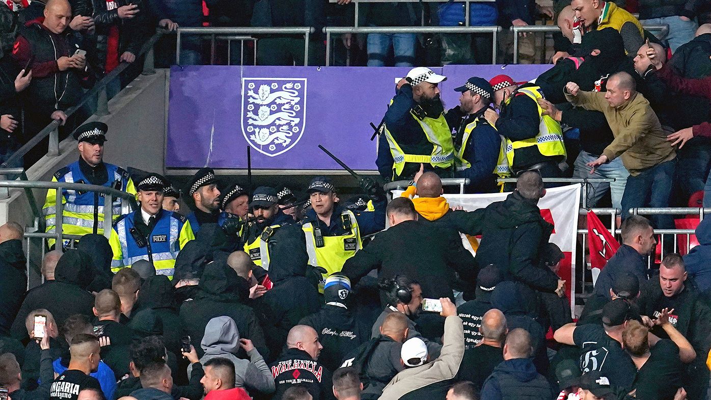 Hungary fans clash with police officers in the stands during the World Cup Qualifying soccer match between England and Hungary at Wembley Stadium.