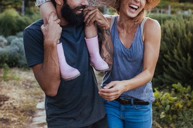 Couple holding their young daughter