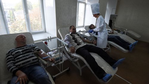 Kerch locals donate blood to help in the aftermath of the school massacre.
