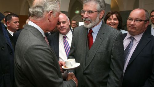Prince Charles shakes hands with Sinn Fein leader Adams