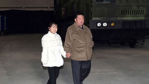 North Korean leader Kim Jong Un inspects an intercontinental ballistic missile (ICBM) with his daughter in this undated photo released in November 2022.