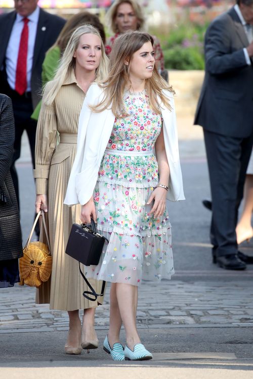 Princess Beatrice mixes a floral dress with a white jacket for the opening day of the show (AAP)