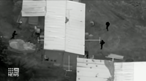 Aerial footage shows police descending on the property before the arrest. 