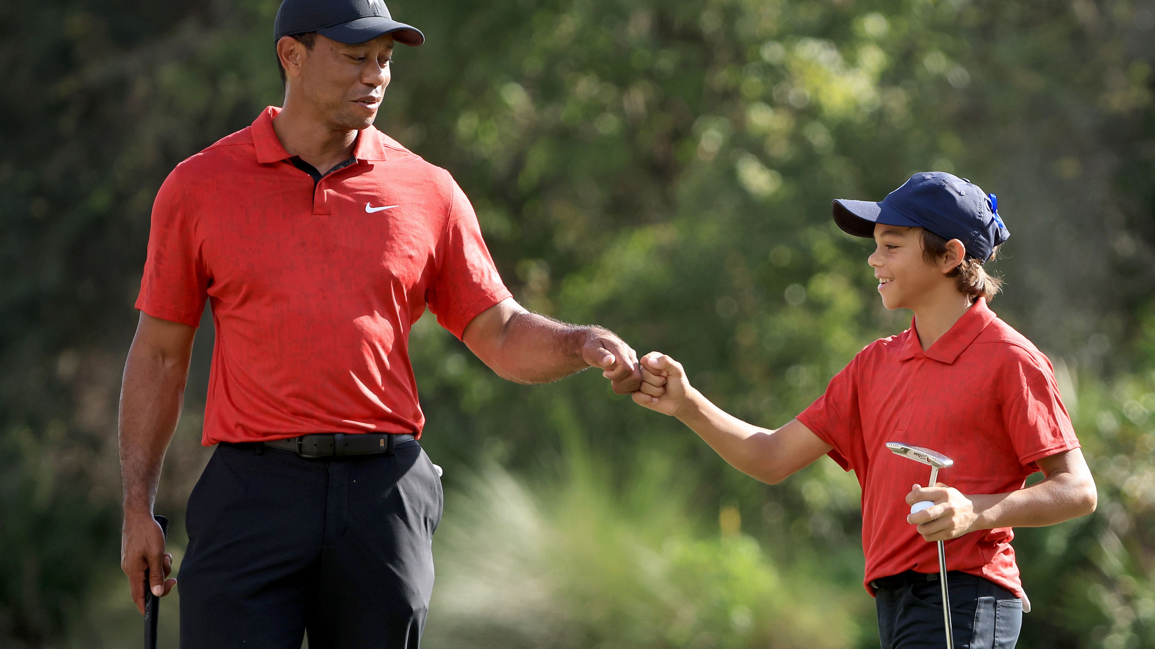 Tiger Woods and Charlie Woods celebrate a birdie on the 12th hole during the final round of the PNC Championship.