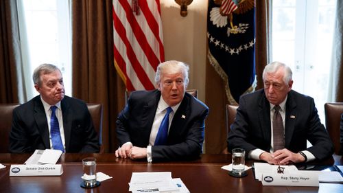 Senator Dick Durbin, D-Ill., left, and Representative Steny Hoyer, D-Md. listen as President Donald Trump speaks during a meeting with lawmakers on immigration policy in the Cabinet Room of the White House in Washington on January 9, 2018. (AAP)