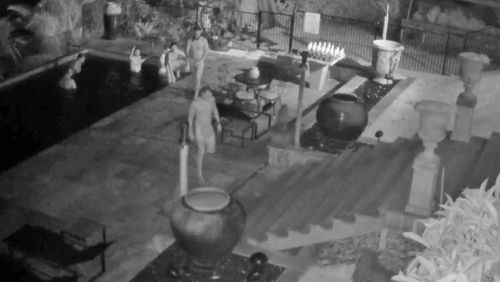 CCTV shows the intruders swimming in the pool of the luxury Bryon Bay home. 