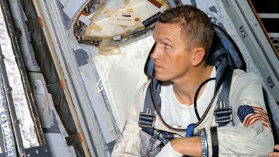 Astronaut Frank Borman, command pilot for the Gemini-7 spaceflight, looks over the Gemini-7 spacecraft during weight and balance tests.