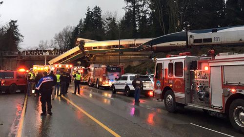 The train can be see danging off a bridge. (AAP)