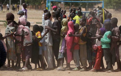 Children displaced after attacks by Boko Haram, line up in the camp of internal displace people, in Yola, Nigeria. (AAP)