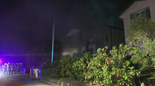 Emergency services were called to the Putney home as thick smoke billowed from the property, but were faced with barbed wire and hoarded items. Picture: 9NEWS.