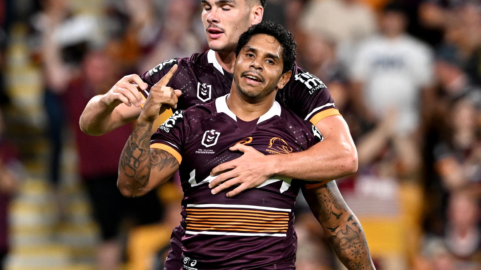 Albert Kelly of the Broncos celebrates scoring a try.