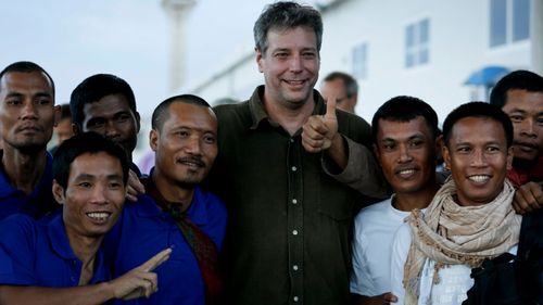 Michael Scott Moore in 2016 with released hostages who were kidnapped from ships by Somali pirates.