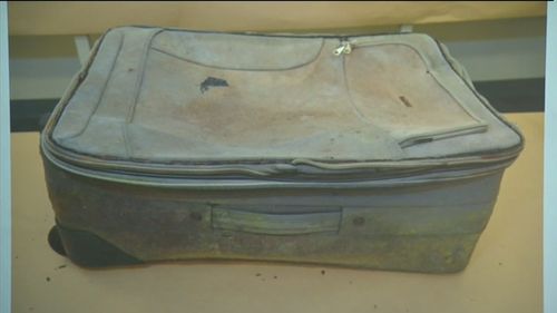 Police have released images of a suitcase, left near the highway. (9NEWS)