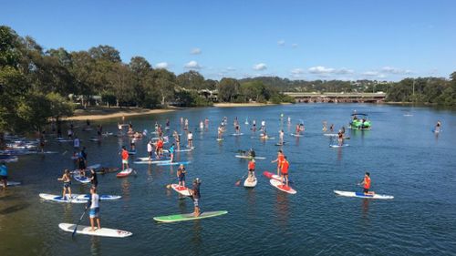 Paddle boarders stand up to domestic violence on the Gold Coast