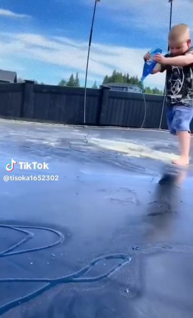 Toddler playing on slippery trampoline. 