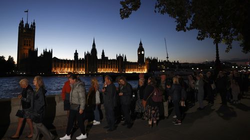 Members of the public stand in the queue in the evening for the Lying-in State of Queen Elizabeth II on September 16, 2022 in London, United Kingdom. Queen Elizabeth II is lying in state at Westminster Hall until the morning of her funeral to allow members of the public to pay their last respects. Elizabeth Alexandra Mary Windsor was born in Bruton Street, Mayfair, London on 21 April 1926. She married Prince Philip in 1947 and acceded to the throne of the Un