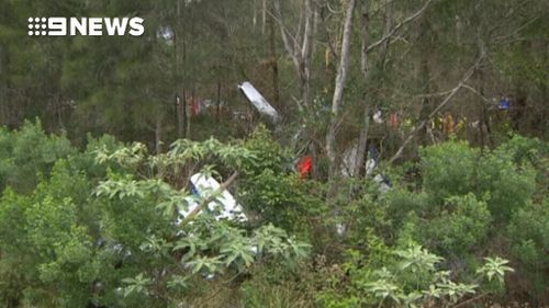 The plane crashed just metres from the road and a railway line. (9NEWS)