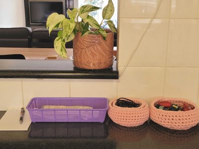 A simple basket helps organise receipts on the kitchen bench entryway.