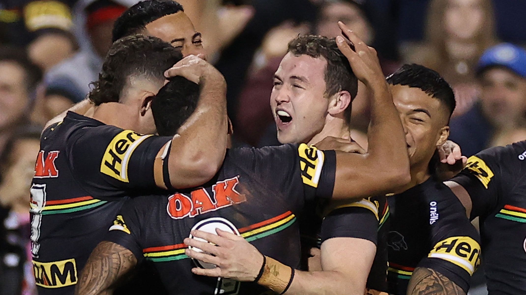 Dylan Edwards celebrates a try with panthers teammates.