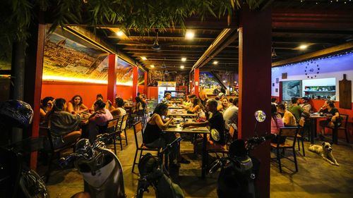 Tourists also drink pizza at a restaurant in Vang Vieng, Laos.