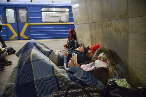 People lie in the Kyiv subway, using it as a bomb shelter in Kyiv, Ukraine, Thursday, Feb. 24, 2022.  (AP Photo/Zoya Shu)