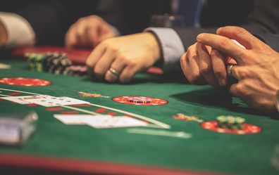 Stock photo of men gambling at a table.
