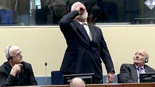 Slobodan Praljak brings a bottle to his lips, during a Yugoslav War Crimes Tribunal in The Hague, Netherlands. (AAP)