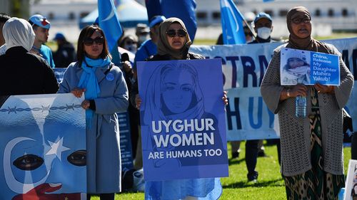 Protesters rally in support of the Uyghur community outside Parliament House in Canberra in March.
