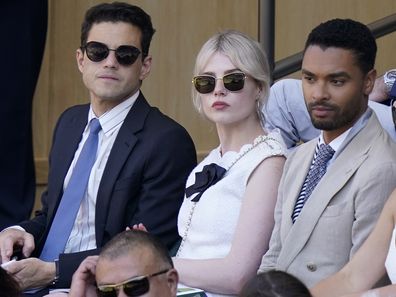 Actors Rami Malik, Lucy Boynton, Rene-Jean Page and Emily Brown, from left, sit in the Royal Box on Centre Court to watch Serbia's Novak Djokovic and Britain's Cameron Norrie in a men's singles semifinal on day twelve of the Wimbledon tennis championships in London, Friday, July 8, 2022 