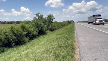 This image made from video provided by KPLC shows a truck passing along the highway where a 1-year-old child was found