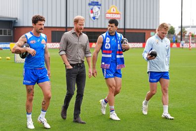 Prince Harry, center left, the Duke of Sussex, meets Western Bulldogs players during a Movember visit at the Western Bulldogs headquarters at Mission Whitten Oval, in Footscray, a suburb of Melbourne, Australia, Wednesday, April 15, 2026. (Jonathan Brady/Pool Photo via AP)