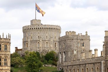 WINDSOR, ENGLAND - SEPTEMBER 19: The coffin of Queen Elizabeth II is carried in The state hearse as it proceeds towards Windsor Castle for The Committal Service for Queen Elizabeth II as the Royal Standard flies above the castle on September 19, 2022 in Windsor, England. The committal service at St George&#x27;s Chapel, Windsor Castle, took place following the state funeral at Westminster Abbey. A private burial in The King George VI Memorial Chapel followed. Queen Elizabeth II died at Balmoral Castl