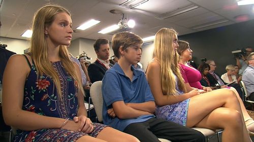 Mr Baird's family watch on as he explains his reasons for resigning. (9NEWS)